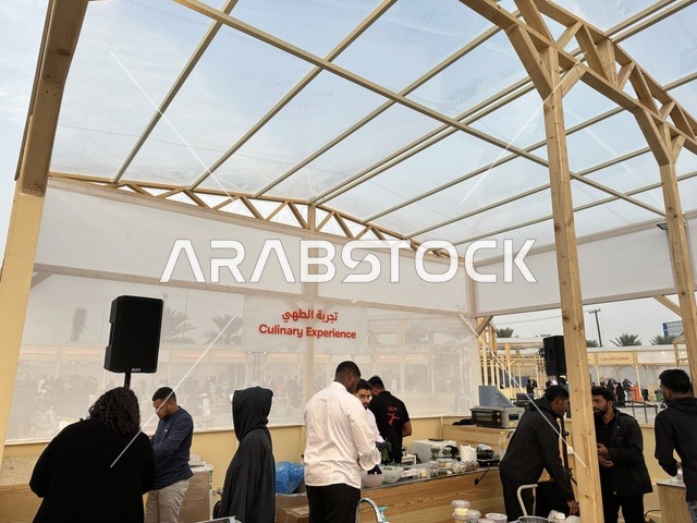 A cooking experience at a food festival in the outdoor gardens of Ithra in Dhahran, Eastern Province, Saudi Arabia, on December 28, 2025. Family-friendly and entertaining atmosphere, a recreational and educational experience, international and local restaurants, diverse global flavors, enjoyable outdoor seating.