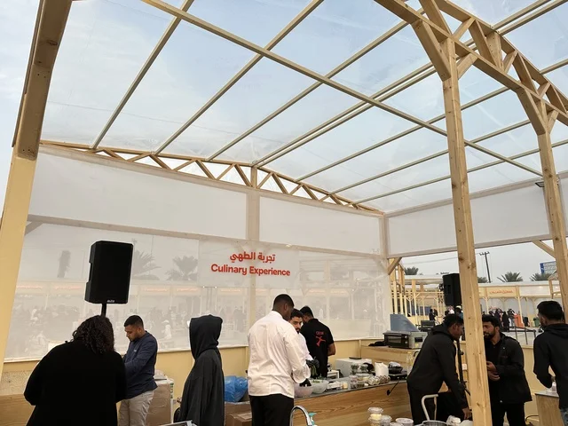 A cooking experience at a food festival in the outdoor gardens of Ithra in Dhahran, Eastern Province, Saudi Arabia, on December 28, 2025. Family-friendly and entertaining atmosphere, a recreational and educational experience, international and local restaurants, diverse global flavors, enjoyable outdoor seating.