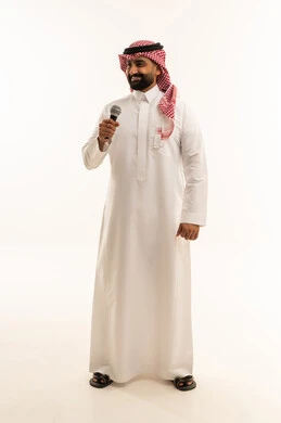 Musical theatrical art, artistic talents in the world of music, presenting a theatrical performance, practicing the hobby of singing for fun and entertainment, a portrait of a Saudi Gulf Arab man wearing traditional attire and a ghutrah holding a microphone in his hand, full-body, white background.