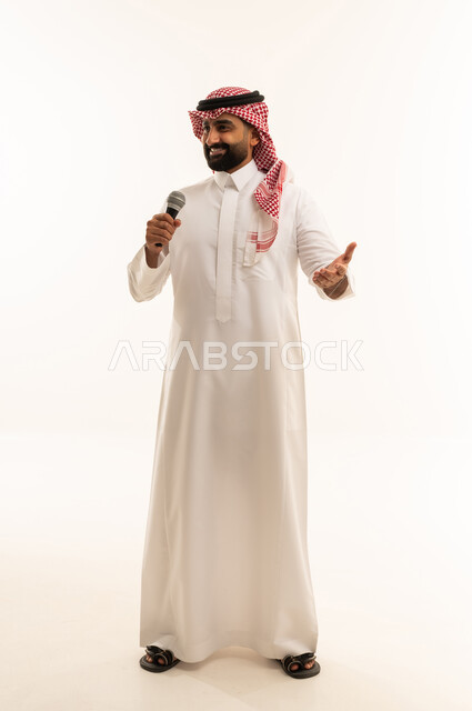 Merging with the song, artistic singing talents, looking at the camera with gestures of joy, recording a singing audio clip, a portrait of a Saudi Gulf Arab man wearing traditional attire and a ghutrah singing using a microphone with expressions of enthusiasm, full-body image, white background.