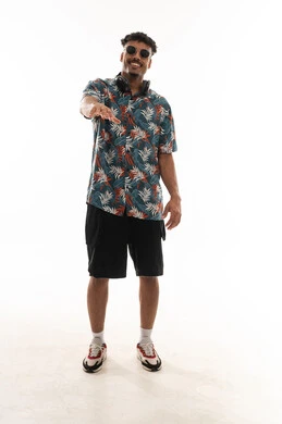A Gulf Arab Omani man wearing casual attire feels happy, raising his arm and spreading his fingers in a smile, portrait with a white background, full body.