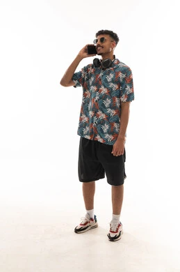 Making phone calls using multiple applications, an Arab Gulf Omani man wearing casual attire, gestures of happiness and smiling, full body, portrait with a white background.