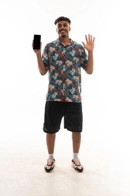 A black empty mobile phone screen in front of the camera, an Arab Gulf Omani man wearing casual attire raising his fingers in a sign of five, portrait with a white background, full body.