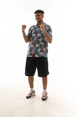 Clenching the fingers of both hands tightly and waving them in the air is a sign of victory and happiness. An Arab Gulf Omani man is wearing casual attire, with gestures of joy and delight, in a portrait against a white background, full-body.