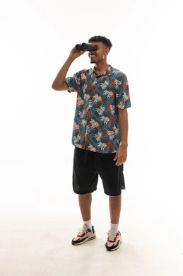 Looking at something far away, an Arab Gulf Omani man wearing casual attire holding binoculars to see distant objects more clearly, portrait with a white background, full body.