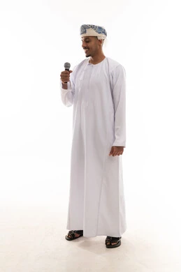Looking at the microphone while singing, an Arab Gulf Omani man wearing a white dishdasha and a turban enjoying his time singing songs, expressions of happiness and joy, portrait with a white background, full body.