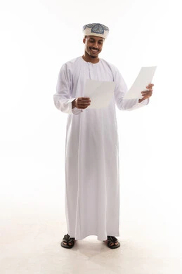 Reading happy news, an Arab Gulf Omani man wearing a white dishdasha and turban holds papers and reads with joy, gestures of happiness, portrait with a white background, full body.