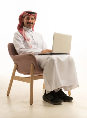 Saudi Man Using Laptop on White Background