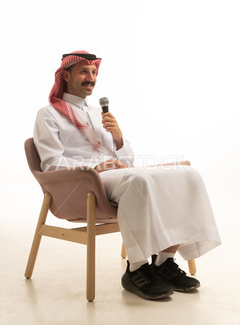 Saudi Man in Traditional Dress Holding Microphone