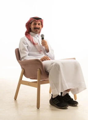 Saudi Man Holding Microphone in Studio Setting