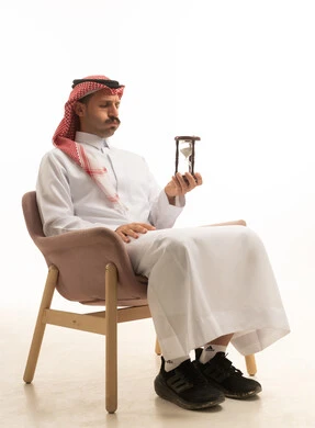 Saudi Man Holding Hourglass on White Background