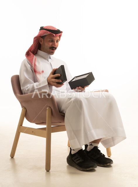Saudi Man Opening Gift Box on White Background