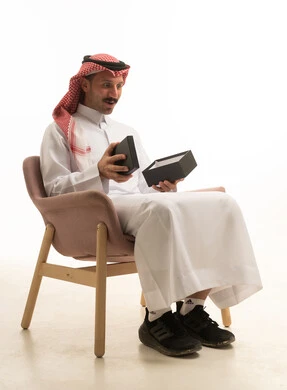 Saudi Man Opening Gift Box on White Background