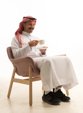 Saudi Man in Traditional Thobe Holding Coffee Cup Studio