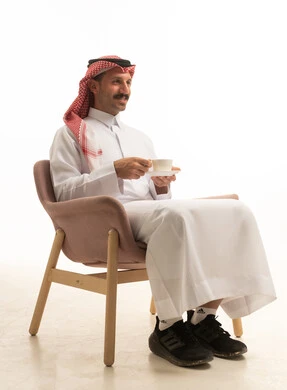 Saudi Man in Thobe Sitting with Tea Cup Studio