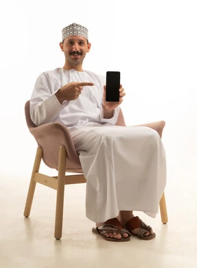 An Omani Arab Gulf man wearing a kumma and dishdasha is holding a mobile phone, sitting on a chair with various gestures and movements, against a white background.