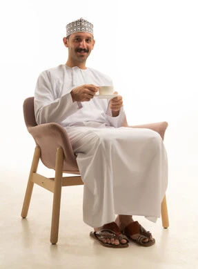 Saudi Man in Traditional Thobe Holding Coffee Cup