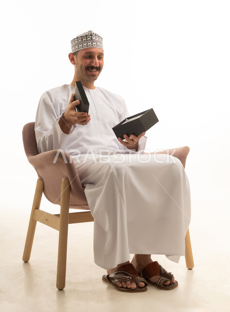 رجل سعودي يفتح علبة هدايا في الاستوديو