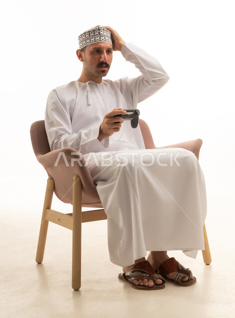 Saudi Man Playing Video Games on White Background