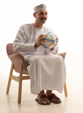 Saudi Man in Traditional Thobe Holding Football in Studio