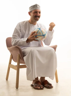 Omani Man with Football Celebrating on White Background