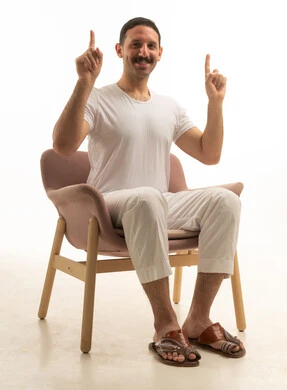 Saudi Man Sitting Pointing Up in Studio