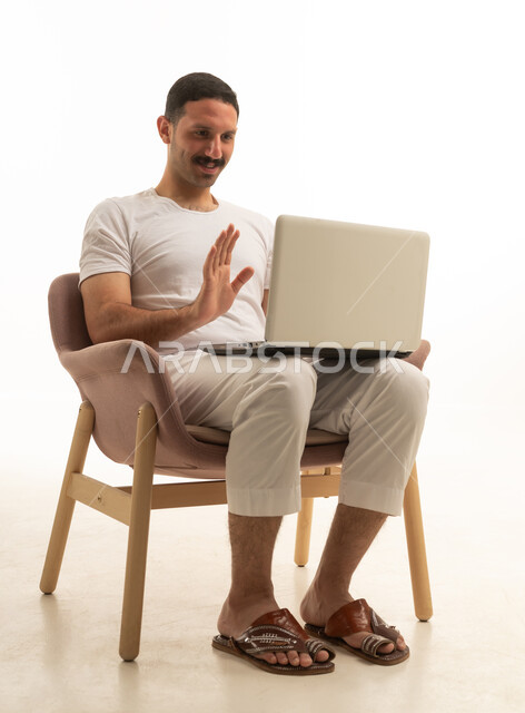 Saudi Man on Laptop Video Call White Background