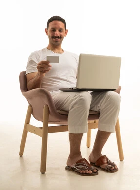 Saudi Man Using Laptop and Credit Card on White Background