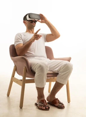 Saudi Man Wearing VR Headset in Modern Armchair