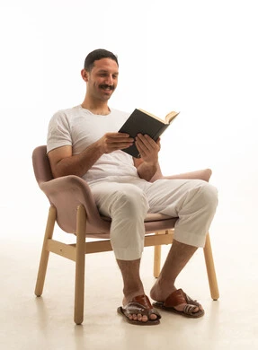 Saudi Man Reading Book in Armchair White Background