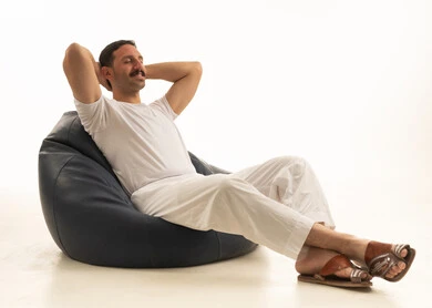 Saudi Man Relaxing on Bean Bag Chair White Background