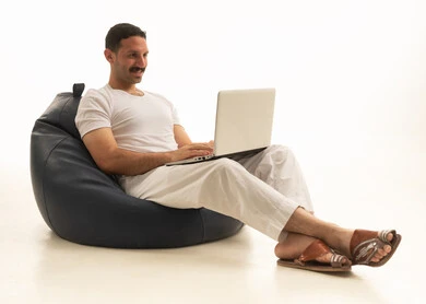 Saudi Arabian Man Using Laptop Sitting on Bean Bag