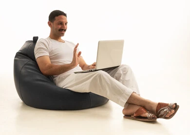 Saudi Man on Video Call Using Laptop Indoors