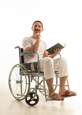 Saudi Man Sitting in Wheelchair Reading Book Studio