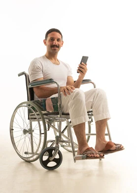 Saudi Man in Wheelchair Using Smartphone Studio Shot