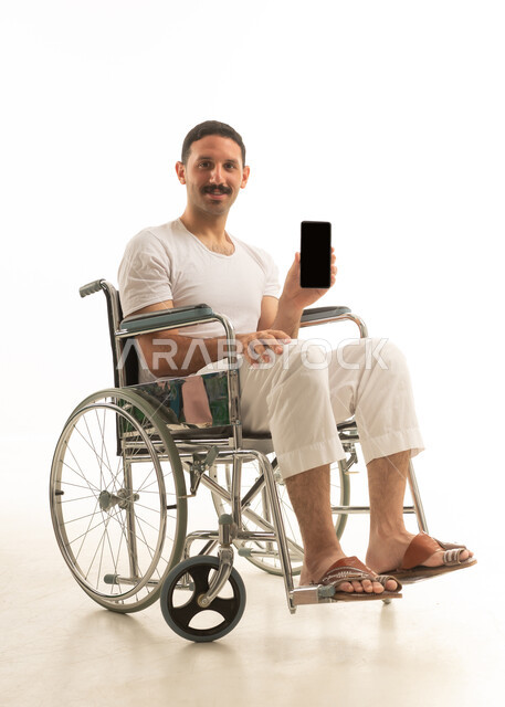 Saudi Man in Wheelchair Holding Smartphone Blank Screen