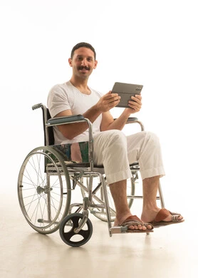 Saudi Man in Wheelchair Using Digital Tablet Studio Shot