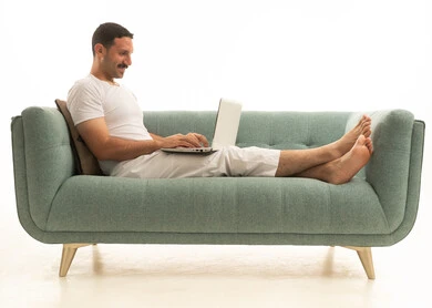 Saudi Man Using Laptop on Modern Sofa