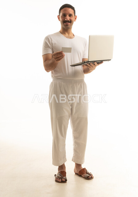 Saudi Man With Laptop And Credit Card Online Shopping