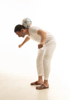 Saudi Man Balancing Football on White Background