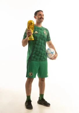 Saudi Football Fan in Green Kit with Trophy
