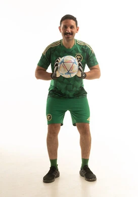 حارس مرمى سعودي مع كرة قدم بخلفية بيضاء