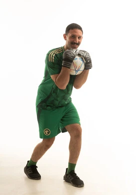 Saudi Goalkeeper in Green Kit Holding Football