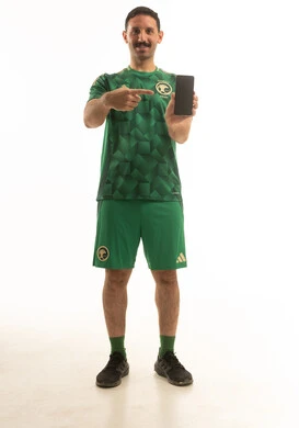 Saudi Football Fan Pointing at Smartphone Screen Studio