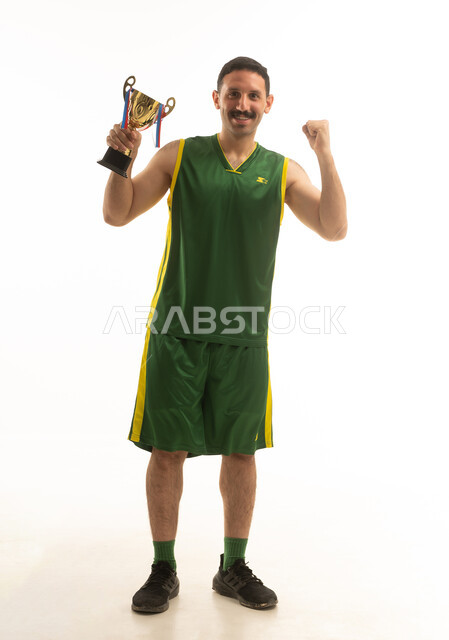 Saudi Sportsman Celebrating with Gold Trophy in Studio