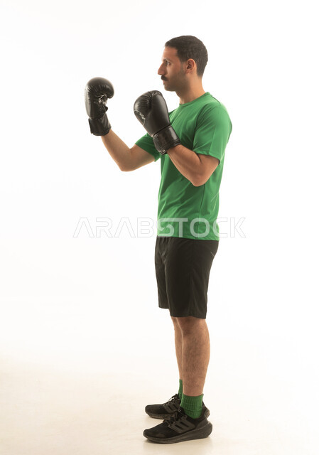 Saudi Man in Boxing Pose with Black Gloves