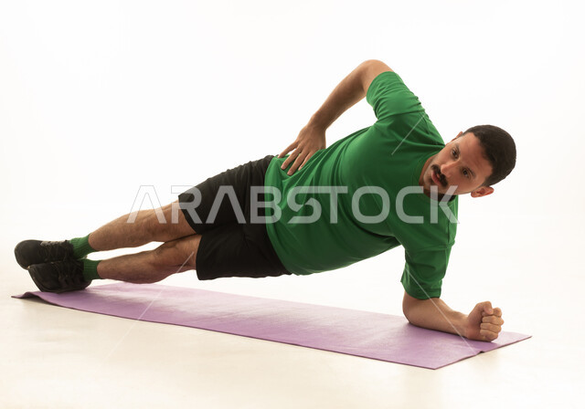 A Saudi Arabian Gulf Arab man wearing sportswear and exercising, an enjoyable physical activity, white background, full body.