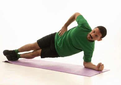 A Saudi Arabian Gulf Arab man wearing sportswear and exercising, an enjoyable physical activity, white background, full body.