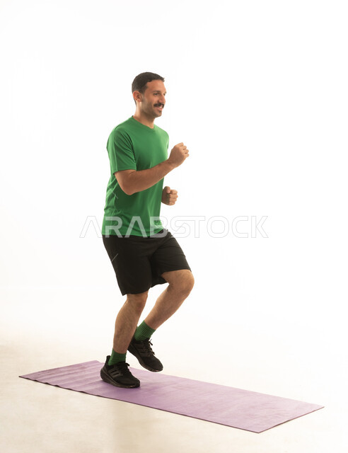 A Saudi Arabian Gulf Arab man wearing sportswear and exercising, an enjoyable physical activity, white background, full body.