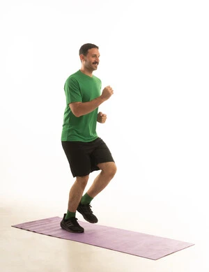 A Saudi Arabian Gulf Arab man wearing sportswear and exercising, an enjoyable physical activity, white background, full body.